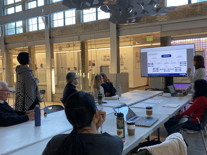 Students present their work to community members in the Hinman Hammock in the Hinman Research Building